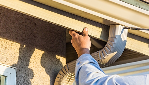 man installing gutters